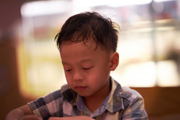 Boy is reading with bored or drowsy