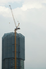 unidentified tower in construction progress with canes