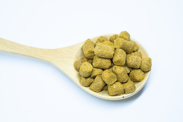 Pellets hops on a spoon wood for home brewing Isolate.