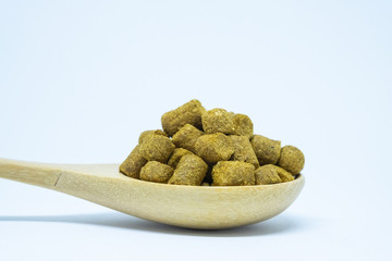Pellets hops on a spoon wood for home brewing Isolate.