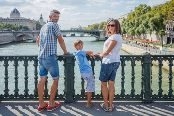 Happy family of three enjoying vacation in Paris, France