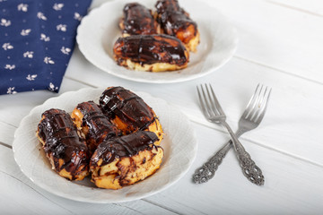Ekler Pasta / Chocolate Donut in plate on white background. 