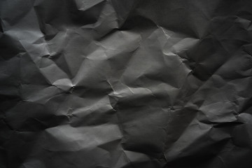 Crumpled gray paper with vignette background texture