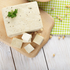 Flat lay view at Soy Bean curd tofu on cutting board Non-dairy alternative substitute for cheese