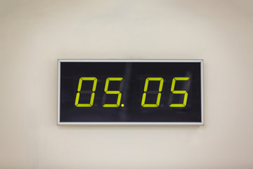 Black digital clock on a white background showing time 05.05