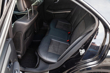Fototapeta na wymiar The interior of the car with a view of the rear seats with light gray trim