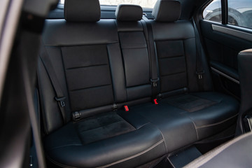 The interior of the car with a view of the rear seats with light gray trim