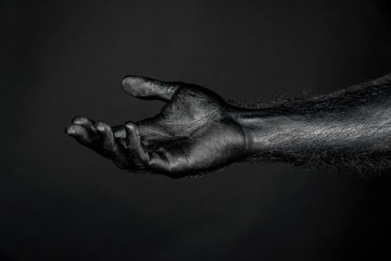 outstretched hand completely in black paint