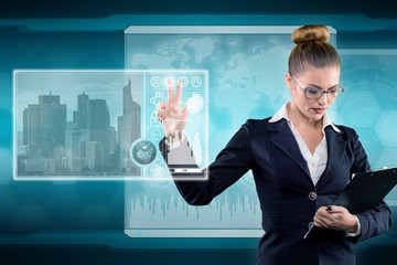 Young business lady works with virtual graphic interface in futuristic office