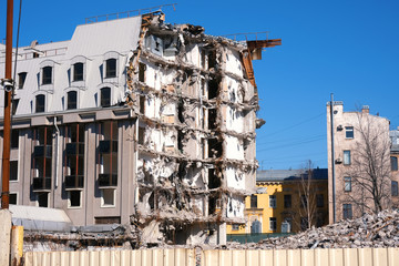 Demolished destructed building ruins. Demolition site in european city. Ruined house on a bright...