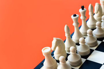 Competition or victory or strategy concept. Chess figures on blue background top view copy space