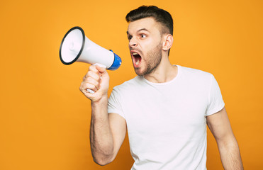Look out! A man with an emotional mimics is holding a megaphone in his hand and screaming to...