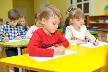 children at school in kindergarten, children learn to write