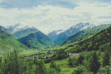 Naklejka premium Small traditional Town in the mountains of Georgia in the Caucasus and snow in the capes