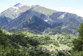 Small traditional Town in the mountains of Georgia in the Caucasus and snow in the capes