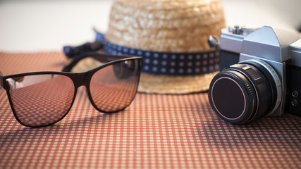 Camera sunglasses and a hat for travel