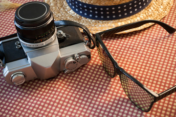 Camera sunglasses and a hat for travel
