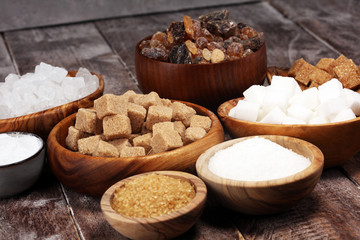 Fototapeta na wymiar Various types of sugar, brown sugar and white on rustic wooden table