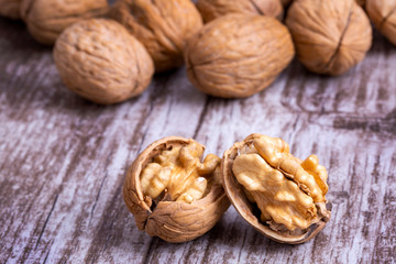 Walnuts on dark vintage table, Walnuts kernels in wooden bowl. Walnut healthy food