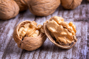 Walnuts on dark vintage table, Walnuts kernels in wooden bowl. Walnut healthy food