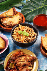 Assorted Chinese food set. Chinese noodles, fried rice, peking duck, dim sum, spring rolls. Famous Chinese cuisine dishes on table. Chinese restaurant