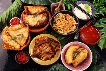 Assorted Chinese food set. Chinese noodles, fried rice, peking duck, dim sum, spring rolls. Famous Chinese cuisine dishes on table. Chinese restaurant
