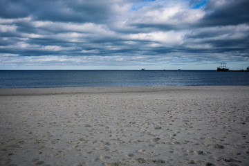 Empty beach background of free space and ocean landscape with dark sky 