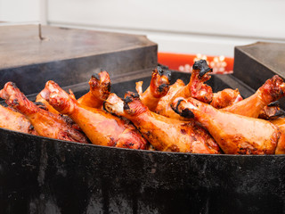 Grilled chicken legs. Outdoor barbecue. Fast food BBQ.
