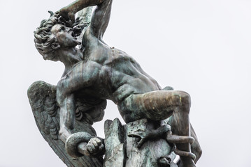 Statue of Fallen Angel on a the fountain in Buen Retiro Park also called simply El Retiro in...