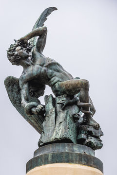 Statue of Fallen Angel on a the fountain in Buen Retiro Park also called simply El Retiro in Madrid, capital city of Spain