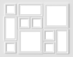 White picture or photo frames on the white wall with copy-space
