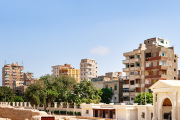 Houses outside the fence of the Serapeum of Alexandria. Ancient architectural landmark in Egypt.