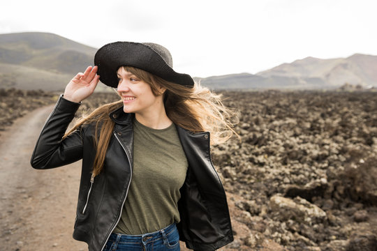 Pretty woman looking away against stony terrain