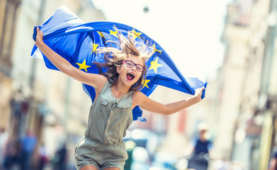 Cute happy young girl with the flag of the European Union © weyo