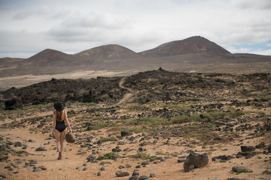 Pretty woman in swimwear in countryside