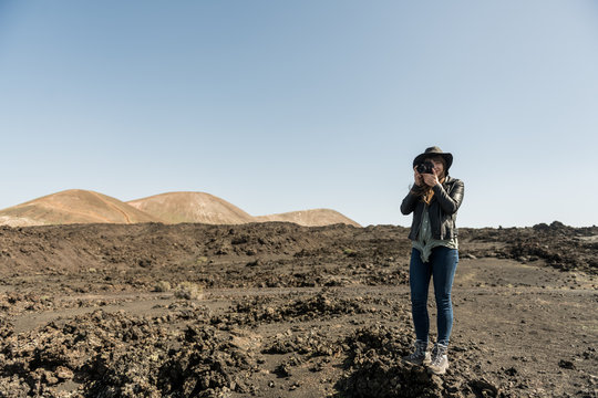 Woman taking photos of countryside