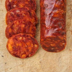 Iberian chorizo, Spanish chorizo ​​or Spanish sausage cut into slices on a wooden board