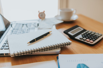 business documents on office table with laptop computer and graph financial diagram and Business people working at office