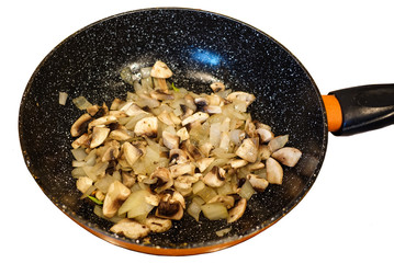 Fried mushrooms in the pan. Isolated on white background