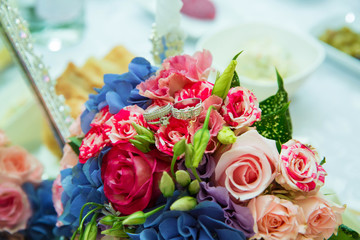 Wedding rings. Selective focus . Multicolored wedding gown.