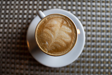 coffee in a white cup on the table.