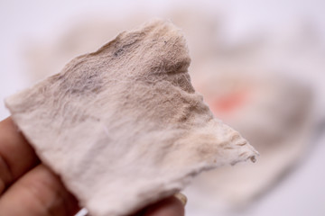 Obraz premium Dirty used cotton pads and stains from remover make up cosmetics on isolate background.