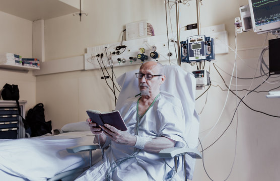 Older man admitted to a hospital room due to health problems - Powered by Adobe