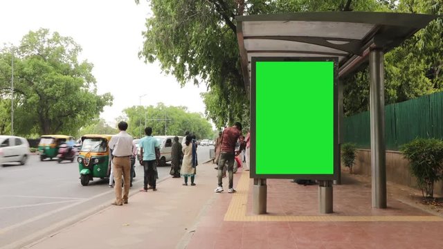 A time lapse of people waiting at bus stop where bill board is available for advertisements near India Gate in New Delhi, India on 18.04.2019. 