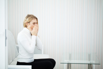 Head pain. Young woman keeping hand on her head