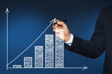 Businessman writing against color background, closeup view of hand with space for text