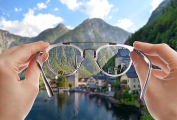 Beautiful view of city among mountains near river on sunny day