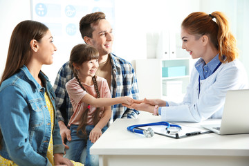 Family with child visiting doctor in hospital