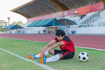 Portrait of asian soccer player warm up before big match in the field,Thailand people