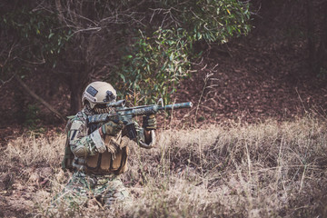 Military camouflage to find opportunities to shoot enemies in the grass,soldier war concept
